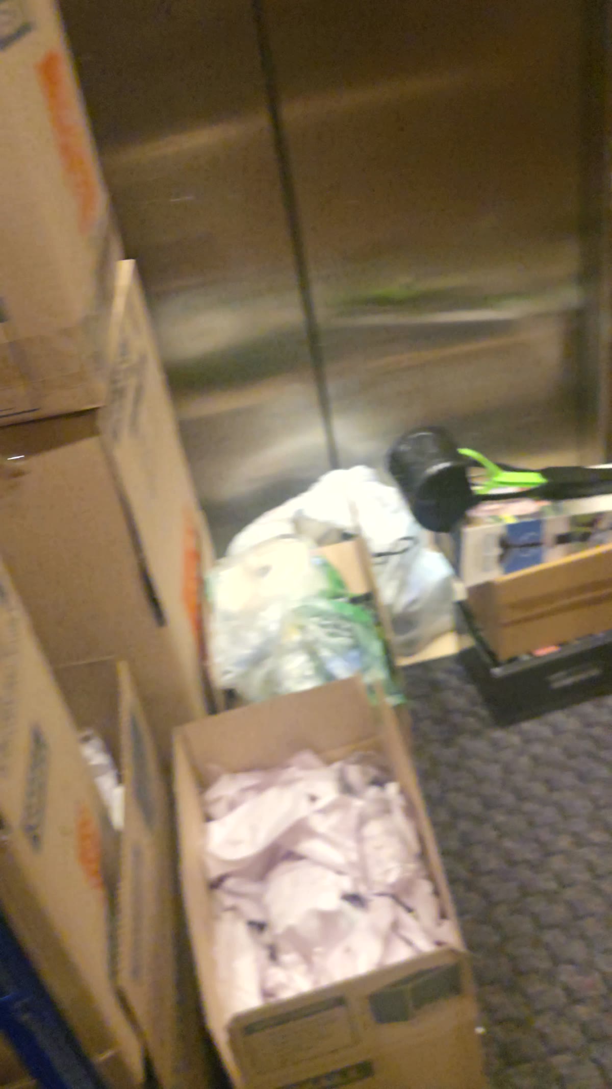 Before shot of boxes, bags, and stacked clutter during a cleanout project