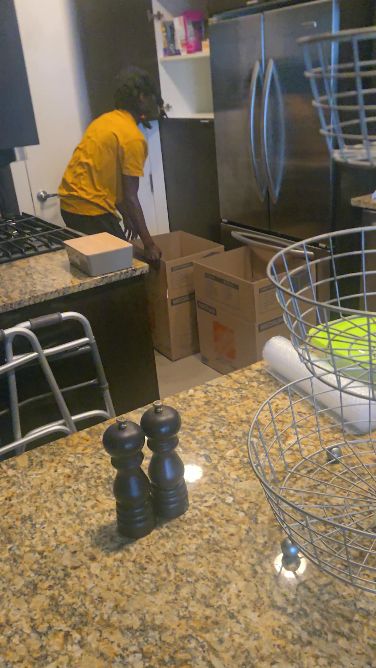 Next Step Junk Removal actively boxing and clearing a kitchen cleanout job